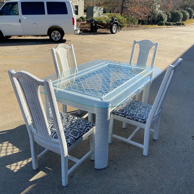 Beautiful white wicker dining set with chairs. Glass tabletop included. Perfect for any space and the interior designer....
