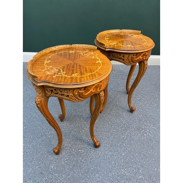 An exceptional pair of 20th-century French Louis XV occasional tables featuring richly figured yew and mahogany...