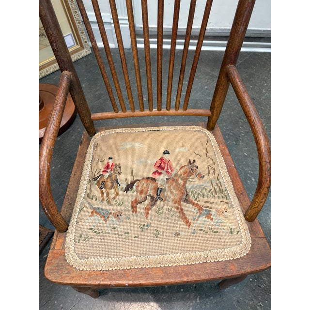 Charming English Childs Windsor armchair crafted in warm elm with a classic spindle back and turned legs. The seat is...