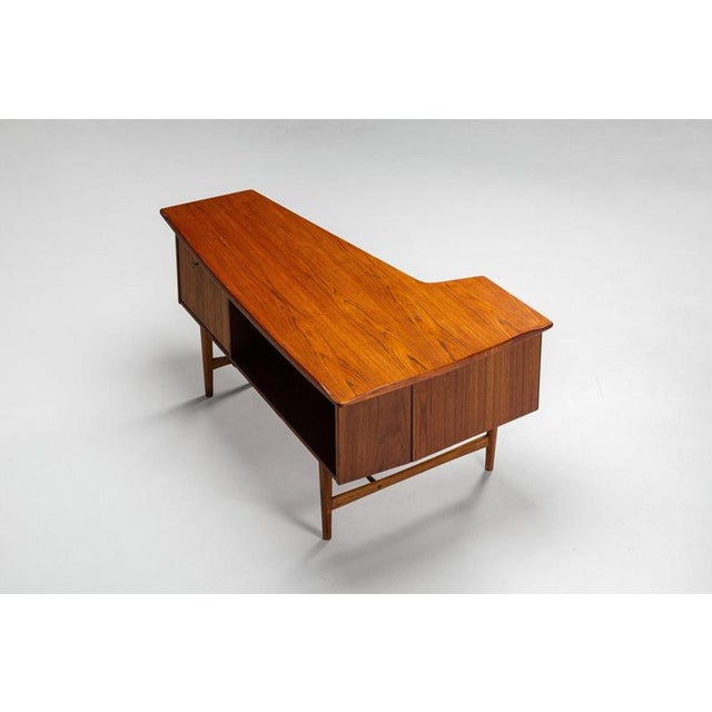 A sculptural boomerang-shaped writing desk designed by Peter Løvig Nielsen and produced by Løvig in Denmark during the...