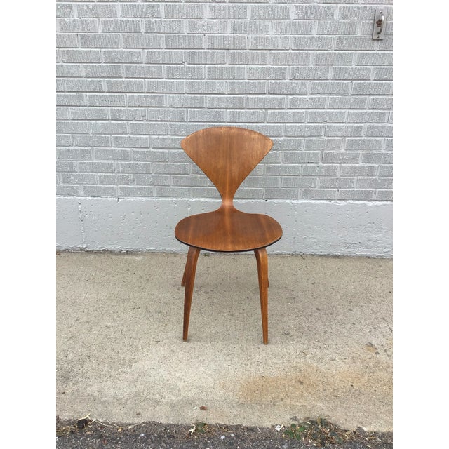 Iconic mid-century modern side chair Attributed to Norman Cherner, circa 1950s. This sculptural chair exemplifies...
