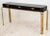 Classic console table designed by John Widdicomb for Mastercraft. Composed of a large black lacquered wood top with canted...