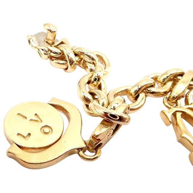 The Cartier 18k yellow gold charm link bracelet features iconic LOVE and Trinity motifs alongside a signature Double C and...