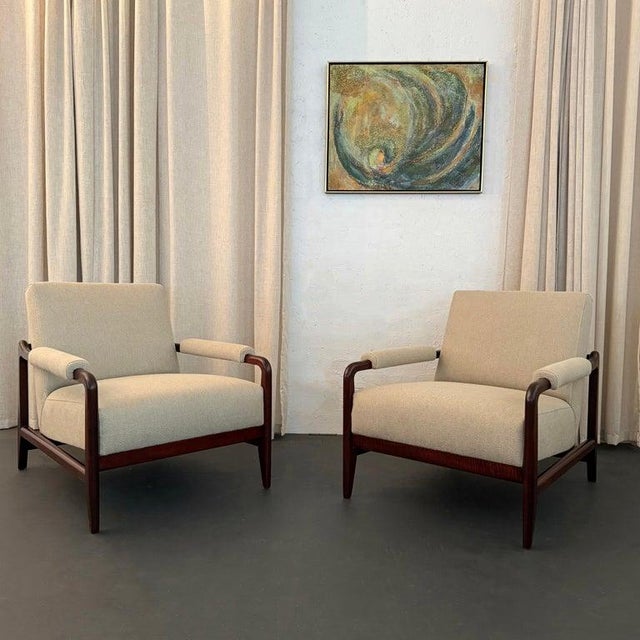 This exceptional pair of Mid-Century Modern armchairs circa the 1960s is all about scale and subtle yet distinct touches....