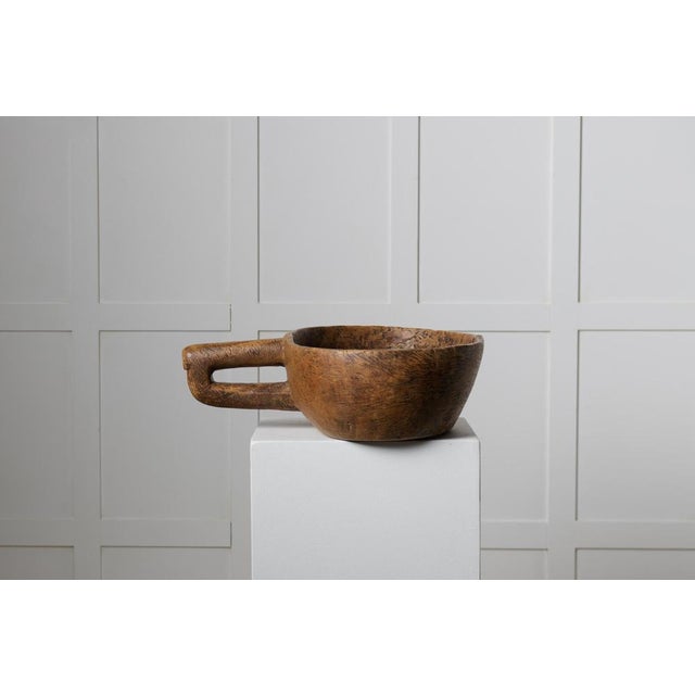 Rare Swedish antique bowl from the late 1700s. This wooden bowl is oval with a large carved handle on the side, a very...