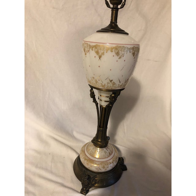 Very unique brass and gilt glass table lamp with matching glass finial. Three female caryatids form the column that holds...