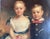 19th Century American Folk Art oil on canvas portrait of two children. These adorable children are probably siblings. She...