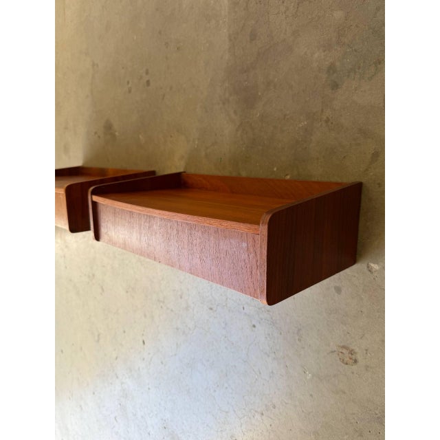 Pair of authentic Mid-Century Modern Danish teak floating nightstands, circa 1960s. These wall-mounted bedside shelves...