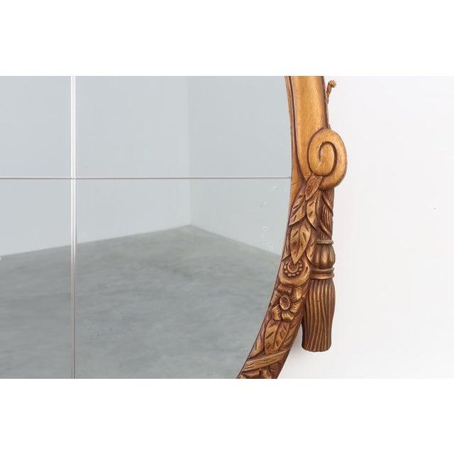 This French Art Deco mirror from around 1925 captures the refined glamour and sculptural elegance that define the period....