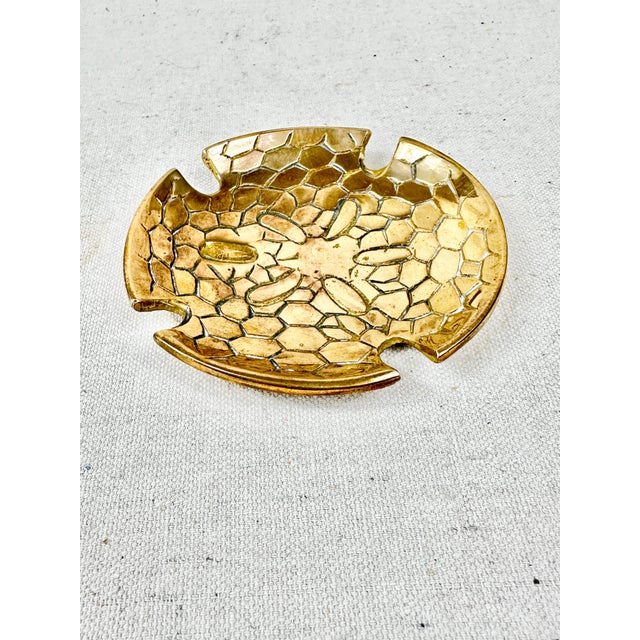 Fun vintage brass trinket dish. Made in the shape of a sand dollar. Perfect to use on a desk with small desk accessories...