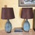 Beautiful pair of turquoise pottery table lamps featuring a glossy ribbed ceramic base with deep blue and teal tones,...