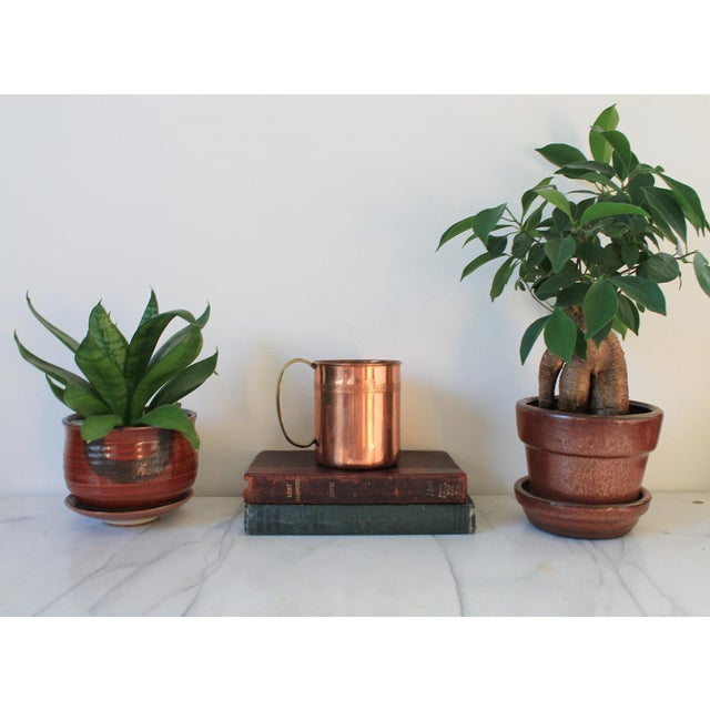 Vintage copper cup or mug with brass handle. No makers mark. Some age wear to brass and copper finish.