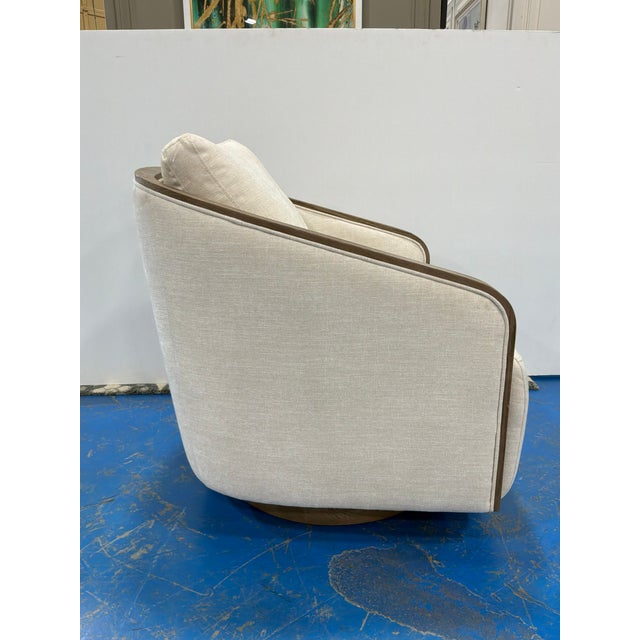 Stylish Swivel chair with wood trim, cream micro chenille fabric. Showroom floor sample.