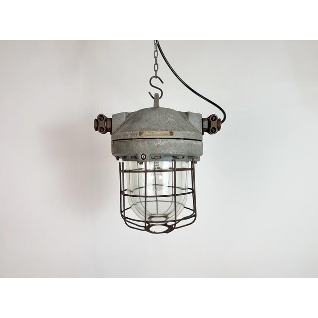 This industrial light was manufactured in former Czechoslovakia by Elektrosvit in the 1960s. It features a grey cast...