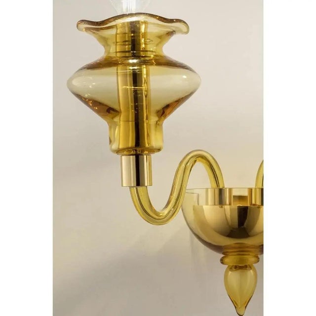 Elegant italian wall sconce in amber made in murano glass and gold plated metal frame. for classical and modern interiors,...