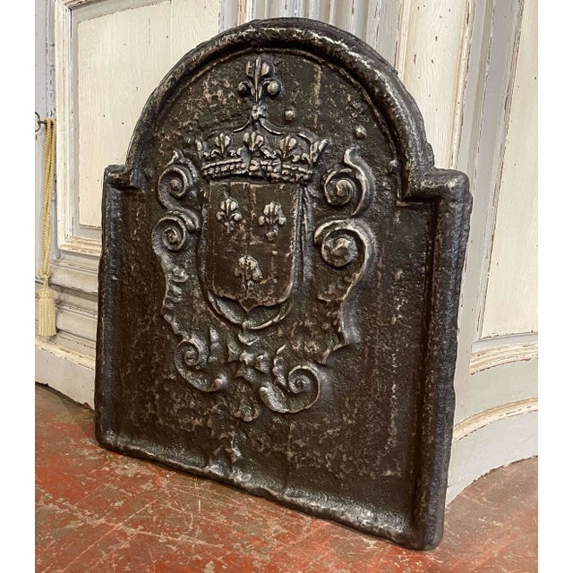 Rich in French heraldic symbolism, this antique cast iron fireback features the Royal Coat of Arms of France in bold...