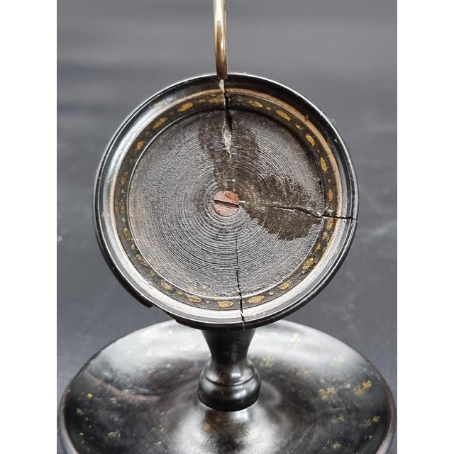 A delicate and elegant table watch holder, crafted from turned ebonized fruitwood, English-made and dating to the first...