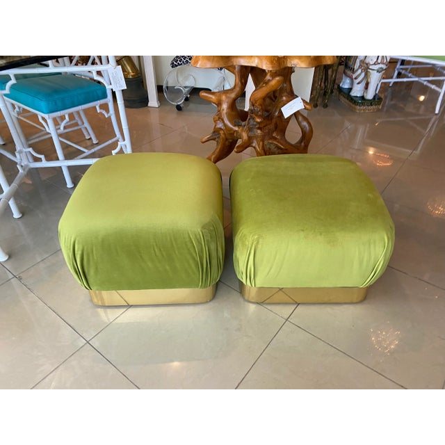 Vintage pair of Karl Springer style poufs, ottomans, benches, stools. Newly upholstered in a moss green velvet. Brass base...