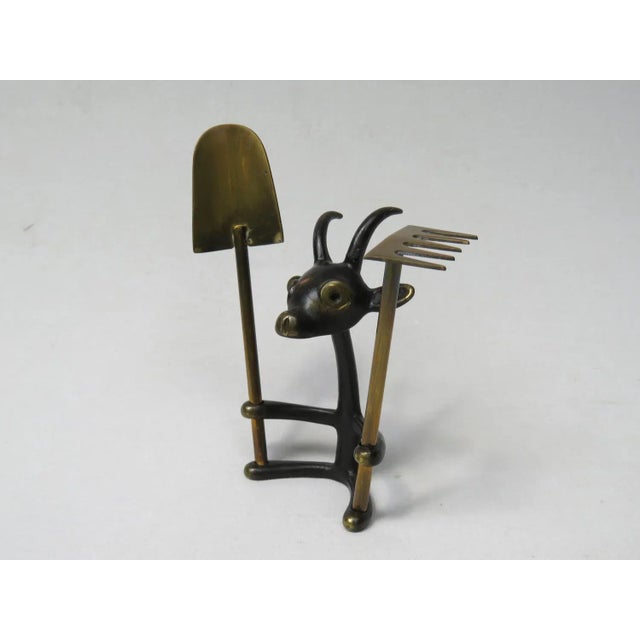 A cactus cutlery billy goat with shovel and rake, made in the 50s, designed by Walter Bosse in brass, patinated and black....