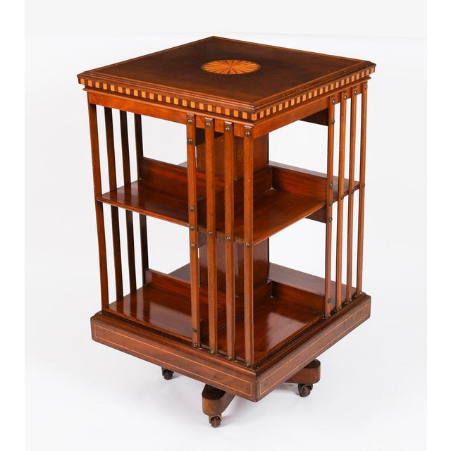 This an exquisite antique edwardian revolving bookcase, attributed to the renowned retailer and cabinet maker, maple & co,...