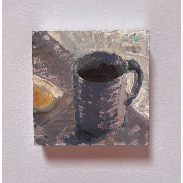 This oil on board painting captures a simple still life featuring a dark mug alongside a slice of citrus. The loose...
