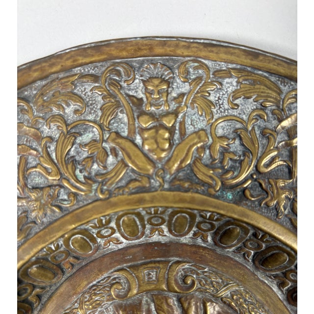 Repoussé bronze offering dish French work, 17th century Decorated with Venus in armor, holding a compass and an armillary...
