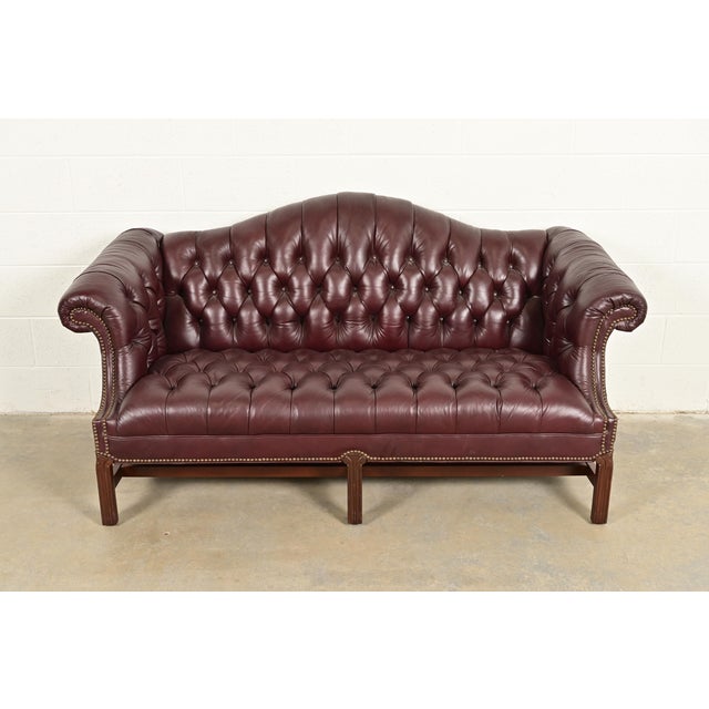 A gorgeous vintage camelback Chesterfield sofa In the manner of Baker Furniture By North Hickory Furniture Co. USA, 1991...