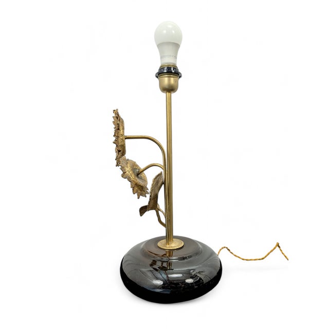 This refined table lamp captures the essence of vintage style with a finely crafted gold-plated brass frame shaped like...