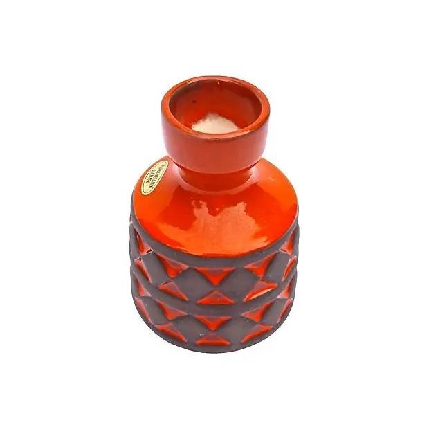 Mid-century modern Danish fire-red vase with a diamond pattern frieze design on the body. Marked "Sóren Holm, Hjorring" on...