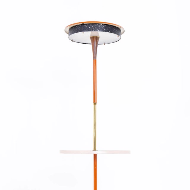 Floor lamp on disc base with central shelf and round lampshade. Wood, brass and metal, partially painted red. European...