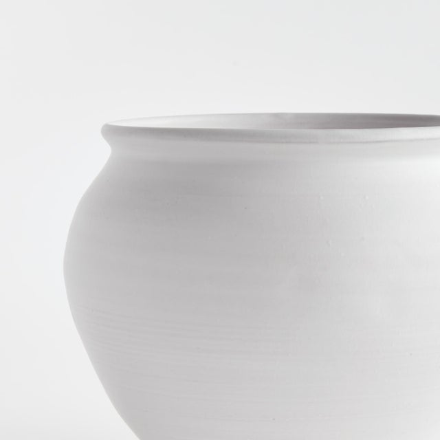 This handthrown terracotta drum vase is finished with a warmWhite glaze and has subtle visible throw lines which only add...