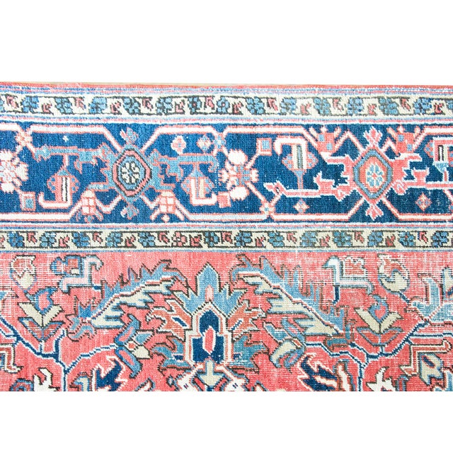 This antique Persian Heriz rug, dating to the 1920s, features a bold geometric design characteristic of the Northwest...