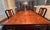 An exquisite and highly elegant seven-piece dining set featuring a magnificent dining table and six matching chairs (one...