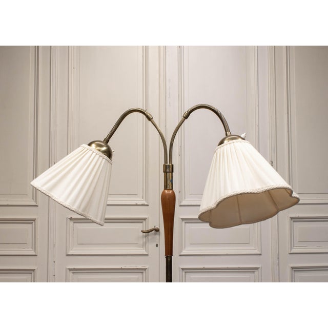 Elegant 1940s Scandinavian floor lamp manufactured by Nordiska Kompaniet (NK). This refined two-shade floor lamp combines...