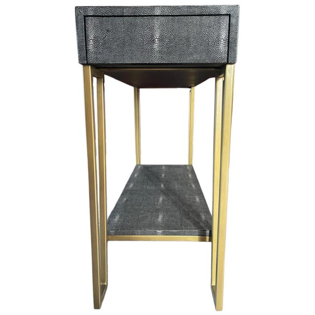 An elegant console table by Currey & Company, model Marlowe. The piece features a shagreen (stingray leather) surface...
