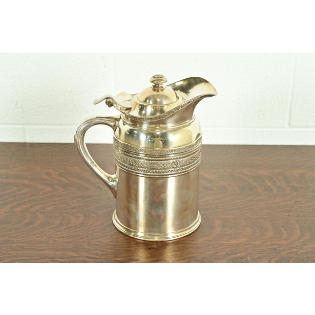 A gorgeous antique Victorian silver soldered repoussé pitcher By Tiffany & Co. (signed to the underside) USA, Late 19th...