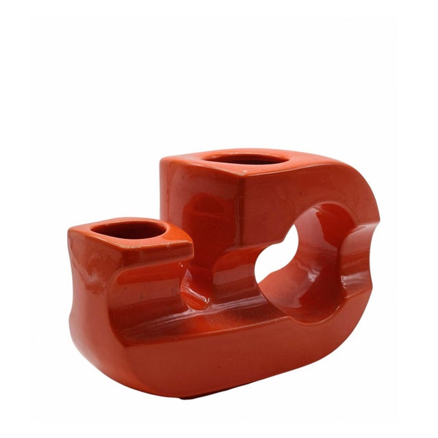 Sculptural ceramic vase with an orange finish. It features a striking postmodern geometric design with two openings,...