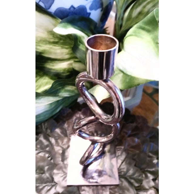 A beautiful silver plated candle stick by the amazing Christofle. The candle holder has heavy circular rings sitting atop...