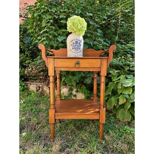 An elegant antique nineteenth-century washstand featuring a shaped wooden gallery with distinctive scrolling side...