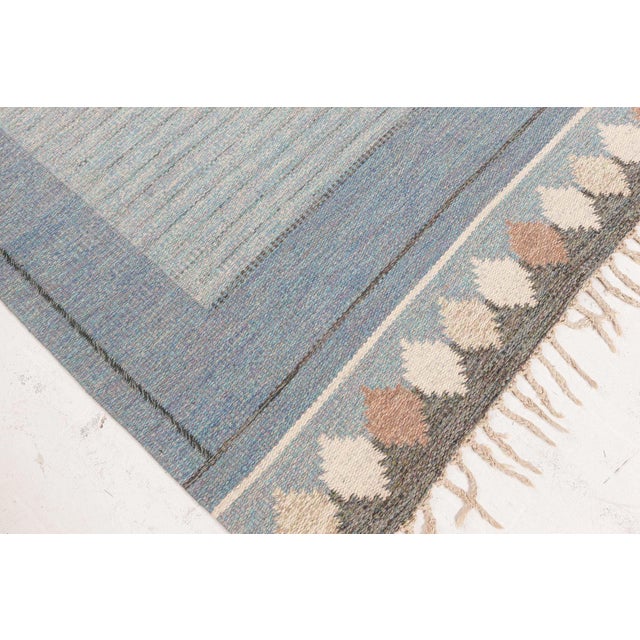 Radiating the serenity of Scandinavian design, this vintage flat-woven rug by Ingegerd Silow exemplifies the iconic...