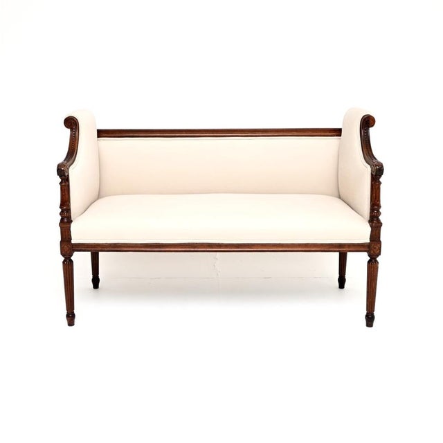 A charming and beautiful antique French scroll end settee, dating from around the 1880-1900 period. It is beautifully...