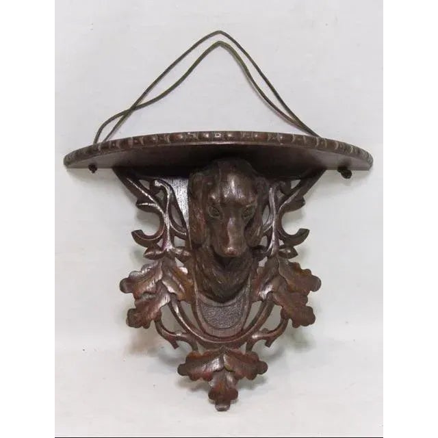 Antique Black Forest King Charles spaniel oak wall shelf, c.1900 Hand carved in Switzerland, in solid oak showing a King...