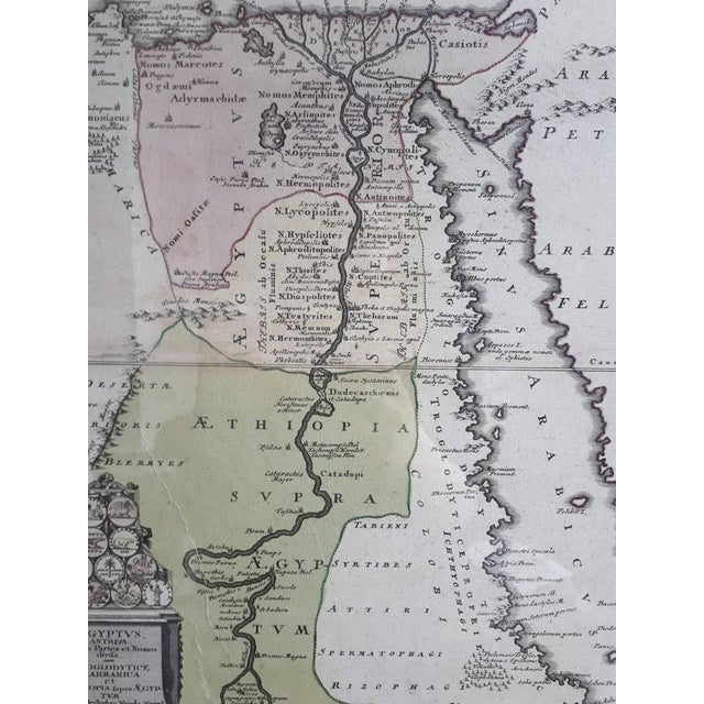 The map is an antique depiction of ancient Egypt, divided into its regions and nomes, also including areas like...