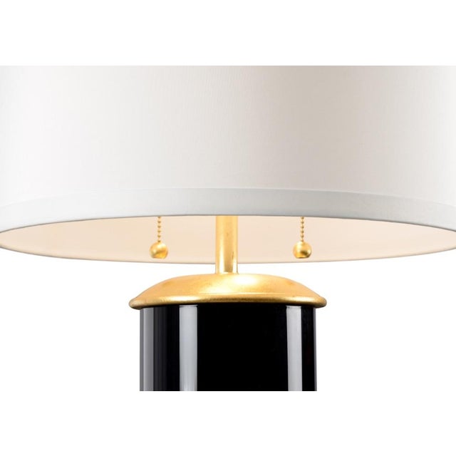 Brighten your home with this charming transitional table lamp. Savannah features a colorful glass cylinder with a dazzling...