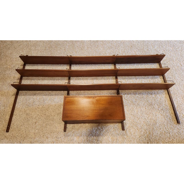 Danish modern teak wall unit designed by Poul Cadovius, circa 1960s. This piece contains 9 shelves, each one measuring 36"...