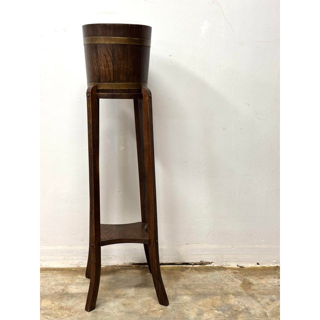 This vintage English coopered plant stand is a beautiful study in craftsmanship, material, and proportion—where a...