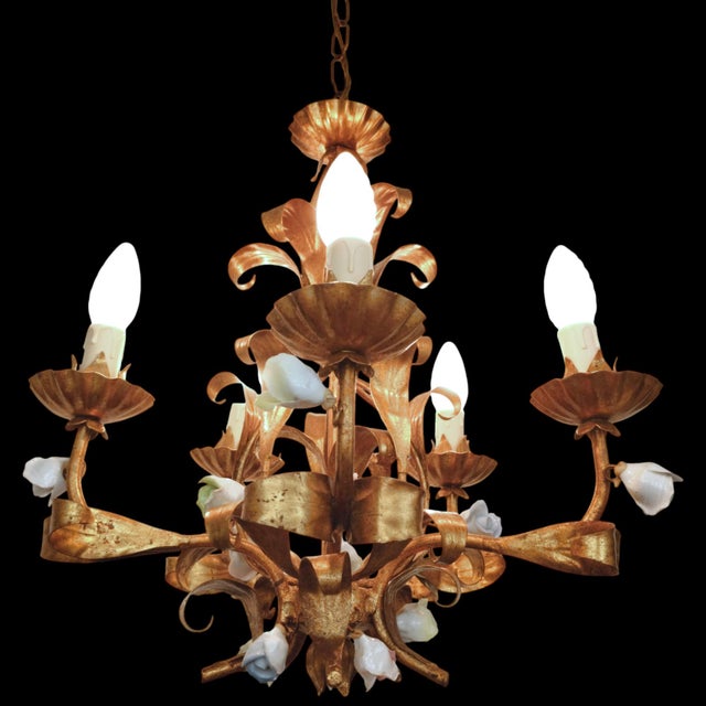 A beautiful 5-arm vintage chandelier from the 1970s, designed in the classic Florentine and Hollywood Regency styles. The...