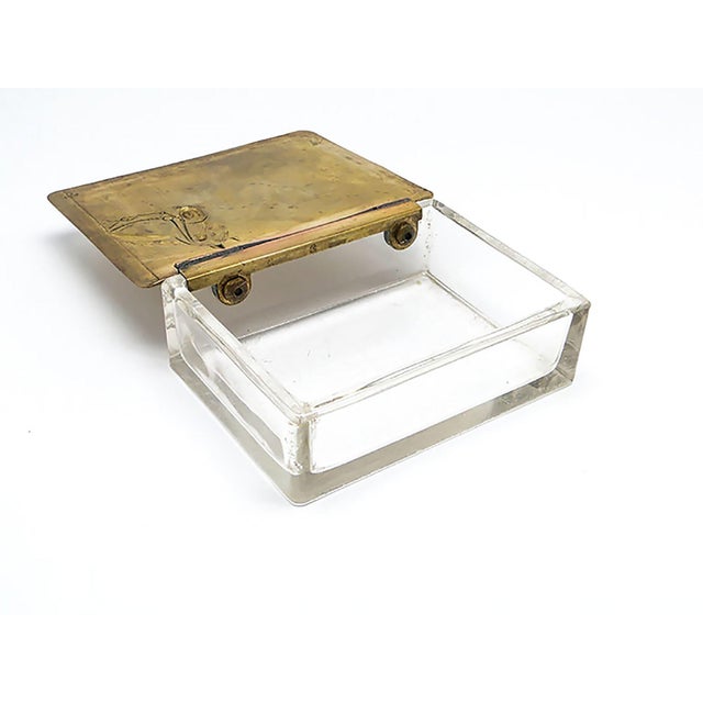 The humidor was manufactured in Germany by WMF between 1900 and 1915. It features an Art Nouveau design with a brass...