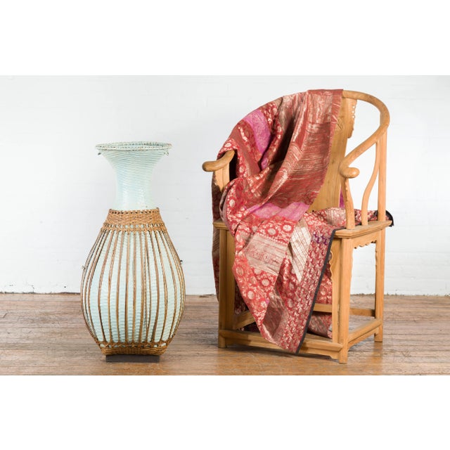 A large vintage Chinese woven rattan basket from the mid 20th century with teal color and base. Created in China during...