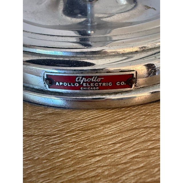 A polished chrome jeweler's lamp wth adjustable shade and pivoting base, USA, circa 1940. Apollo Electric Co. Chicago.